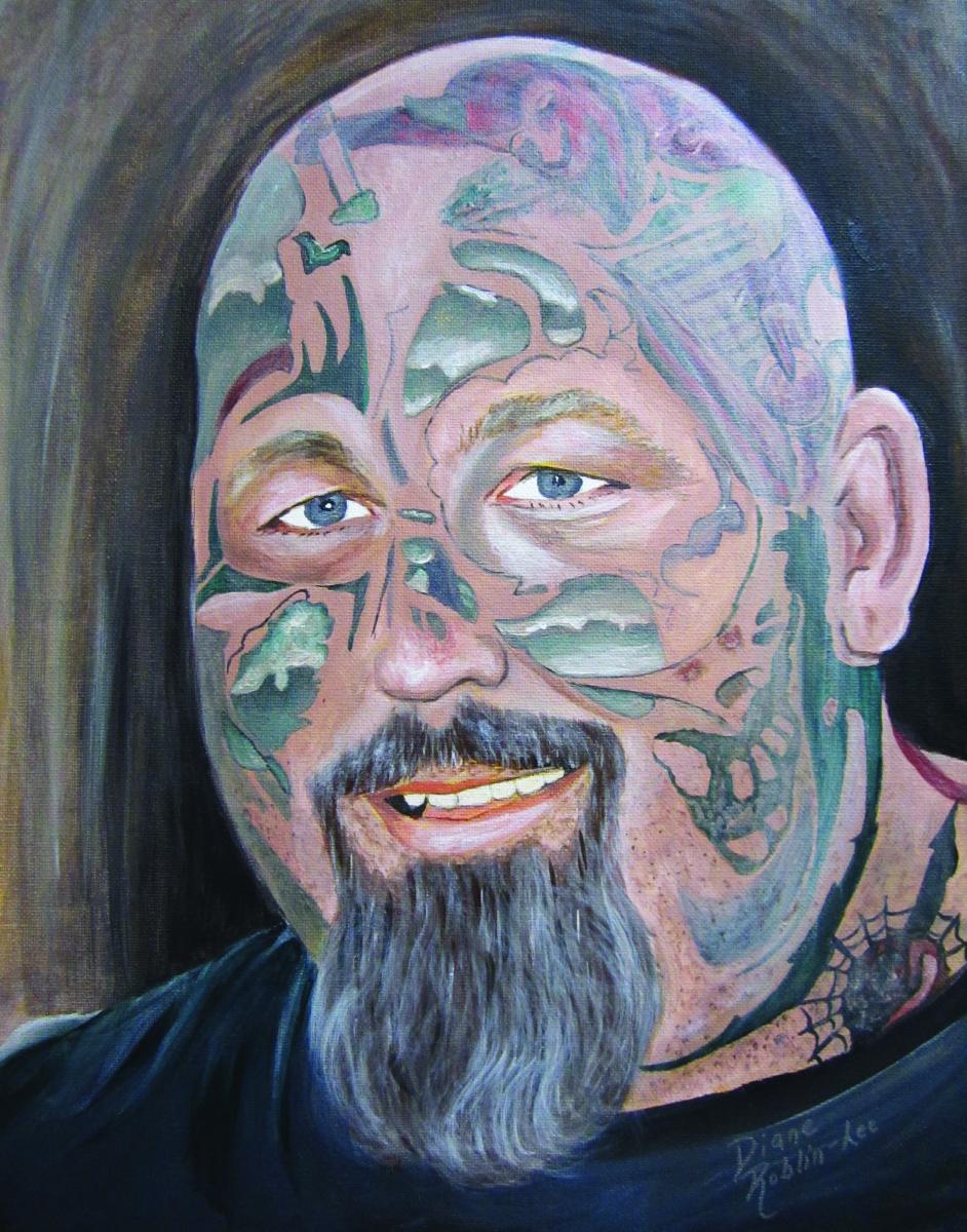 Man with facial tattoos painting